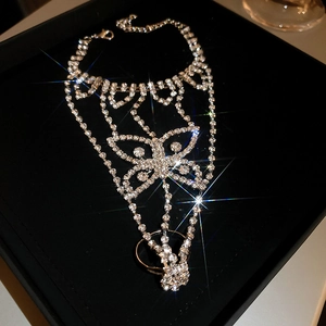 Close-up of sparkling butterfly hand harness with rhinestones and integrated ring