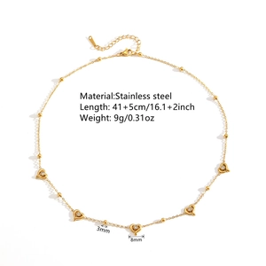 Golden stainless steel heart pendant necklace with beads on a clean white background