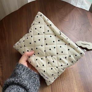 Quilted corduroy makeup bag with black hearts and simple wish label held by hand