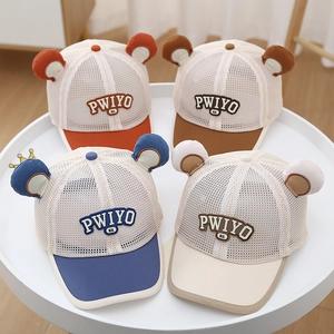 Detailed view of four breathable mesh baby baseball hats with cute bear ears and PWIYO embroidery