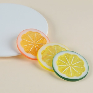 Realistic PVC lemon slices in orange, yellow and green colors on a beige background