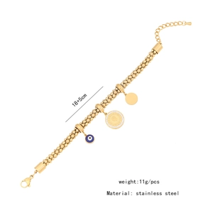 Detail view of gold stainless steel bracelet with blue evil eye and coin charms