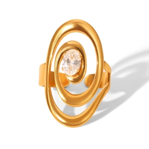 Detail shot of a golden spiral ring featuring a sparkling oval zircon in a modern style