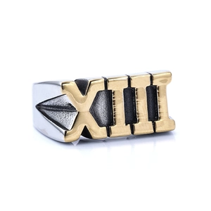 Close-up of wide two-tone stainless steel ring featuring engraved Roman numeral XIII