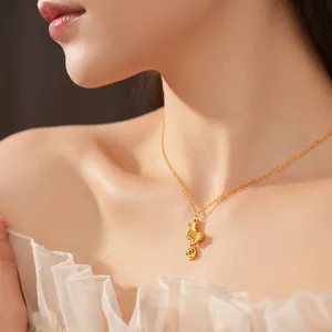 Gold-plated necklace with horse and coin pendant worn by model on white lace top