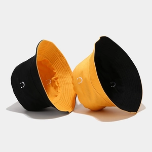 Reversible bucket hat in black and yellow cotton canvas with smile embroidery