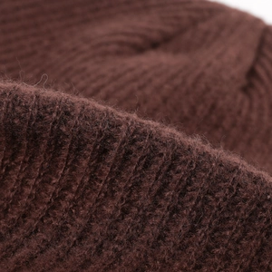 Deep brown ribbed knit beanie hat showing soft thermal texture and detailed vertical weave