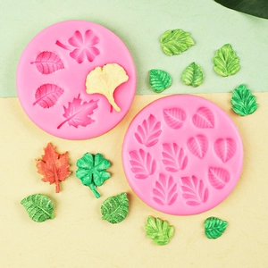Pink silicone mold featuring maple and ginkgo leaf shapes for cake decorating and DIY
