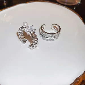 Double layer open ring set with sparkling zircon stones and a delicate white pearl