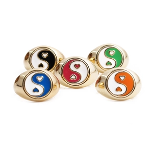 Detail shot of five heart-shaped Yin Yang signet rings in vibrant colorful enamel finish