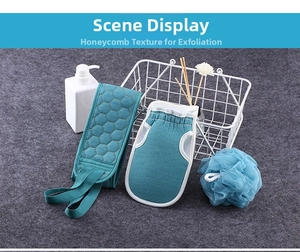 Close-up of three-piece blue bath set with honeycomb towel, exfoliating mitt and sponge