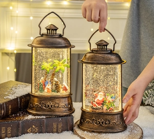 Close-up of vintage bronze Christmas water lanterns with Santa Claus and Nativity scenes