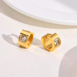 Macro view of gold-plated stainless steel hoop earrings featuring square-cut clear zircon