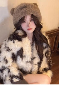 Close-up of cute brown plush bear ear hat with fluffy faux fur texture detail
