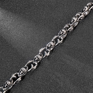 Macro shot of double skull link bracelet in vintage silver stainless steel with black patina
