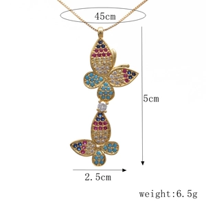 Detailed view of gold butterfly pendant featuring colorful cubic zirconia stones and sizing info