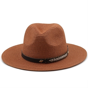 Close-up of brown straw fedora with black leather band and vintage gold buckle detail