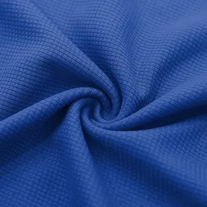 Macro detail of royal blue waffle knit fabric showing breathable textured mesh pattern