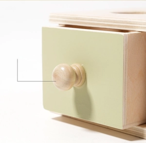 Macro detail of natural wood texture and round handle on Montessori drawer box toy
