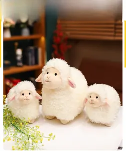 Three assorted sizes of soft white plush sheep toys with curly fleece texture