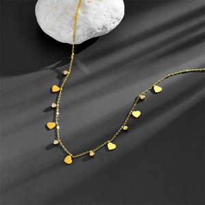 Close-up of gold stainless steel necklace with heart charms and cubic zirconia details