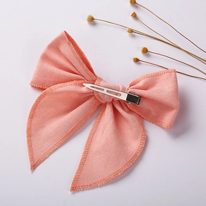 Pink linen cotton bow hair clip for girls with a silver metal alligator clasp