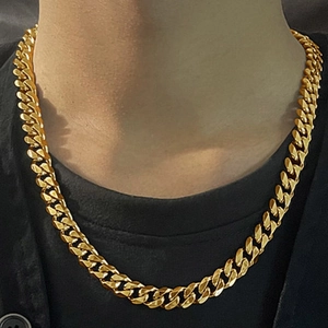 Classic golden stainless steel Cuban link necklace shown on model for hip hop fashion style