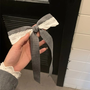 Elegant grey ribbon bow hair clip with white lace trim and long flowing streamers
