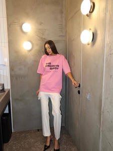 Women pink oversized short sleeve T-shirt with black text print in urban industrial style