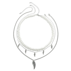 Men's layered silver necklace set with wing charms and white pearls on white background
