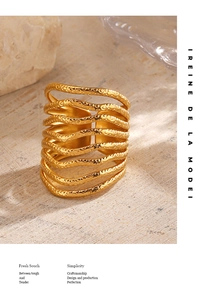 Detail of 18K gold plated multi-layer textured ring with hammered finish on stone surface