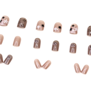 Pink pearlescent press-on nails with star patterns and smile faces in 24-piece set