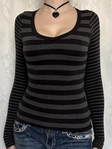 Detail of a casual long-sleeved striped top for women featuring a round neck and grey stripes