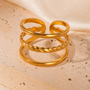 Detailed close-up of a triple-layered gold geometric ring with twist texture on stone