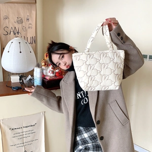 Quilted bunny handbag carried by a model in a warm, minimalist lifestyle setting
