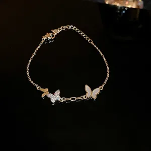 Elegant gold plated butterfly bracelet with zircon stones and white shell charms