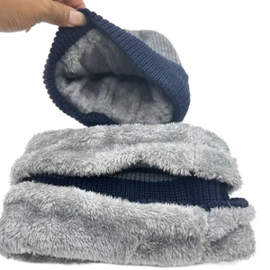 Close-up showing the thick fleece lining of navy knit hat and neck warmer set