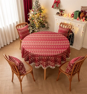Top view of red Christmas reindeer round tablecloth with tassels and matching pillows