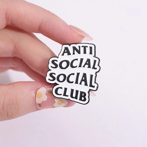 Spilla metallica geometrica con logo Anti Social Social Club in bianco e nero