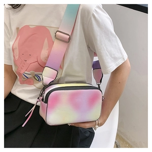 Close-up of vibrant gradient colorful camera bag with wide adjustable shoulder strap