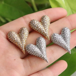 Luxe paved heart stud earrings in gold and silver finishes with shimmering crystals