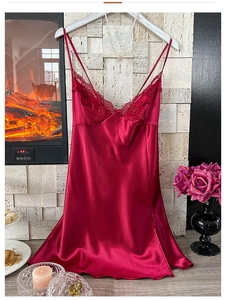 Detail of dark red satin slip nightgown featuring delicate lace trim and thin straps