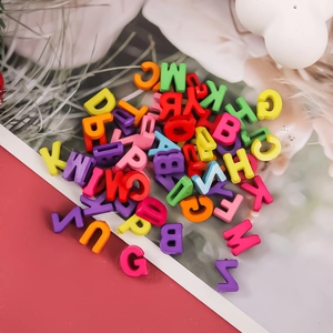 Close-up of colorful acrylic macaron alphabet beads for DIY jewelry and crafts