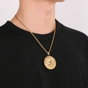 Detailed view of Tree of Life pendant necklace on male model with gold twist chain