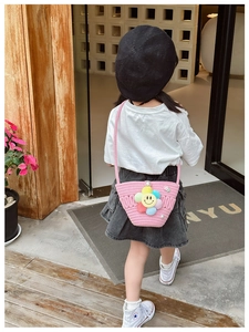 Pink straw crossbody bag for kids featuring colorful sunflower and pearl embellishments