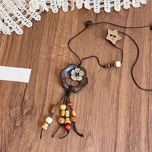Ethnic style long necklace with dark wood flower pendant and colorful beaded tassels