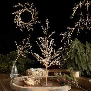 Christmas beaded wreath and crystal tree centerpiece on wooden tray with cozy holiday decor