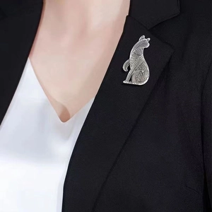 Vintage silver cat brooch with hollow geometric patterns on a black suit lapel