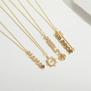 Detailed view of gold-plated MAMA and letter necklaces with shimmering zircon stones