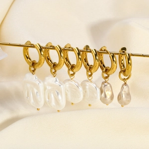 Detailed view of baroque pearls on 18K gold stainless steel huggie hoop earrings